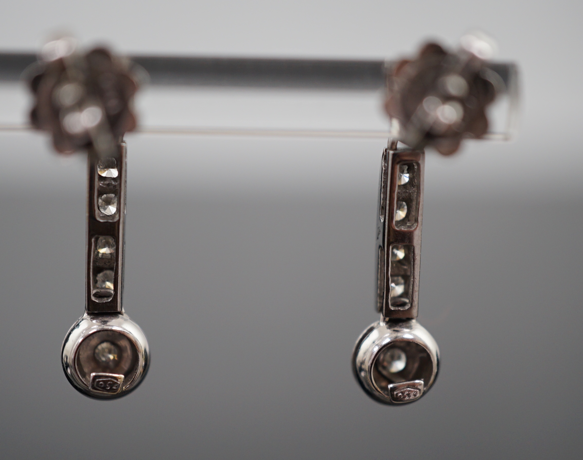 A modern pair of 18ct white gold and six stone diamond set line drop earrings